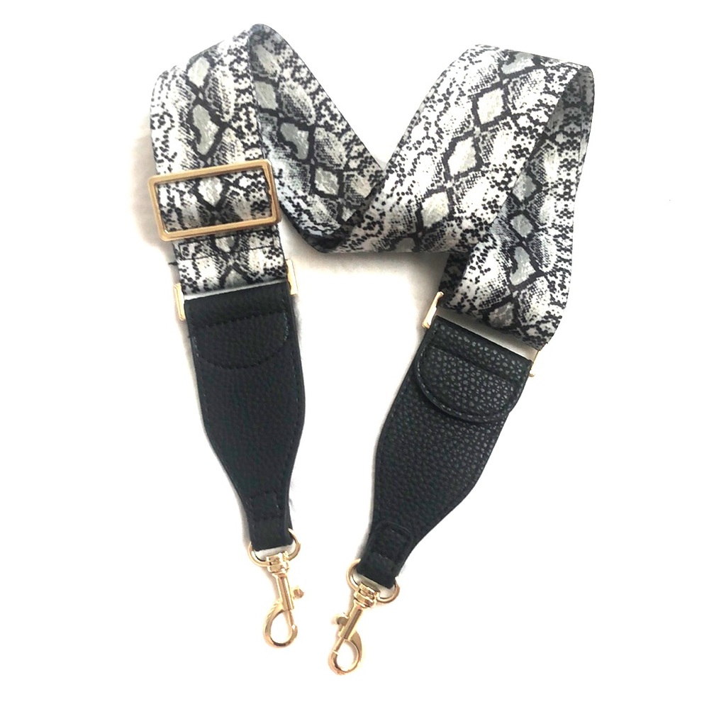 Crossbody guitar strap with gold hardware.